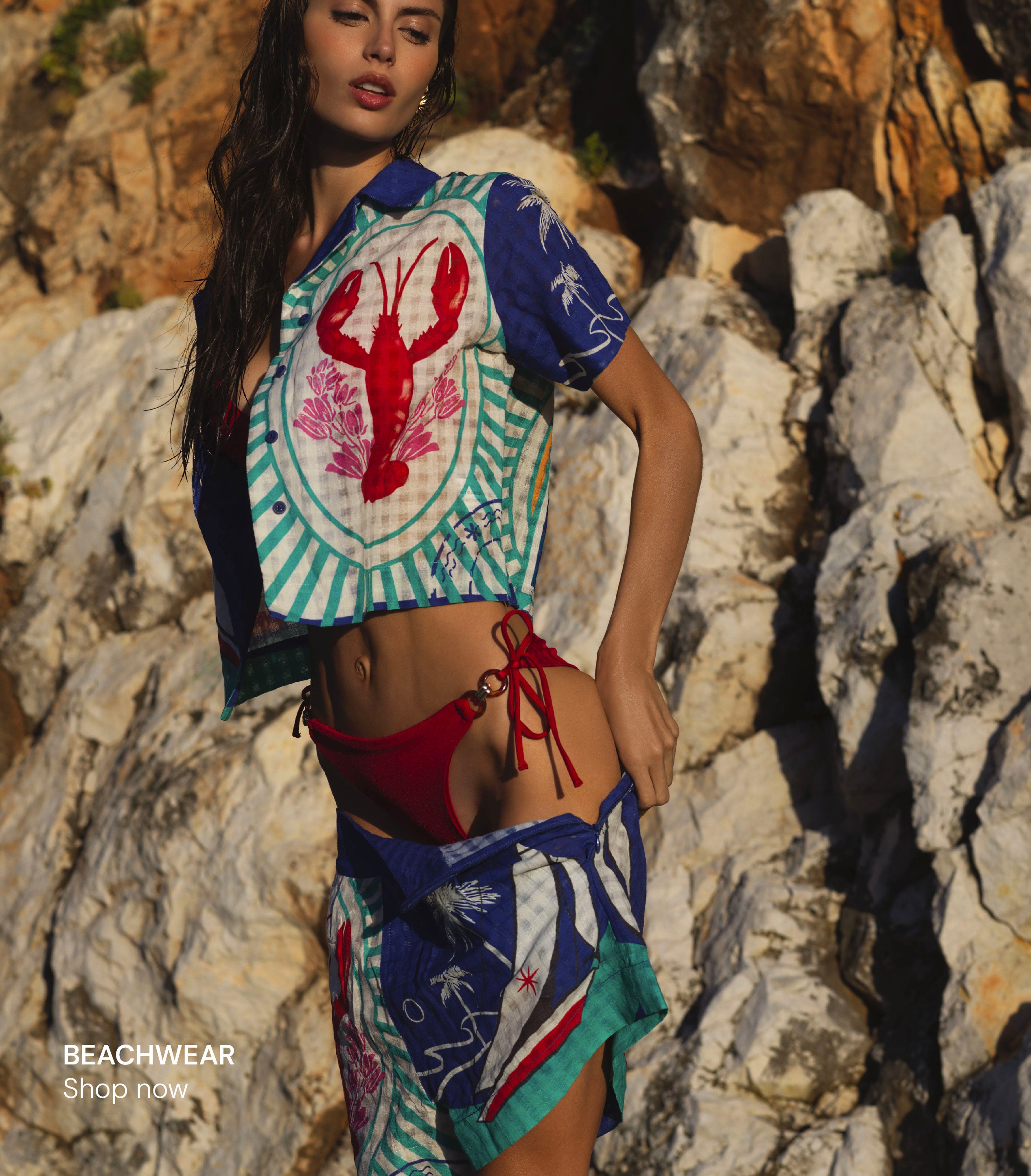 Woman wearing lobster print beachwear set with matching cover-up from luxury coastal resort collection