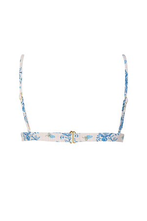 Back view of a blue floral bikini top featuring adjustable shoulder straps, decorative floral details, and a secure hook closure on a soft ivory fabric with a delicate blue floral print.